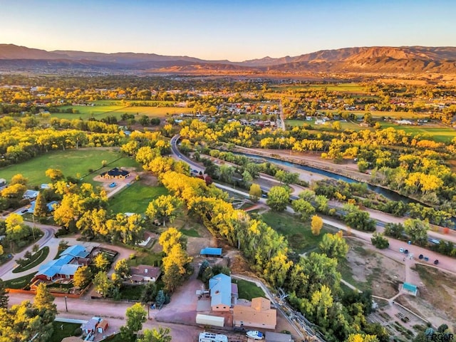 aerial view at dusk featuring a mountain view