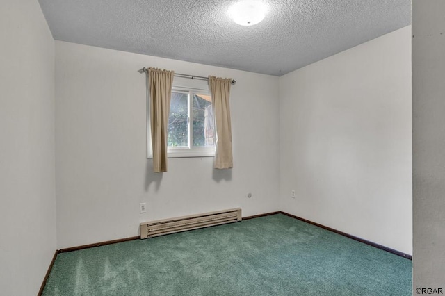 carpeted spare room with baseboard heating and a textured ceiling