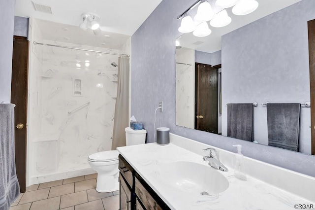 bathroom featuring vanity, curtained shower, tile patterned floors, and toilet