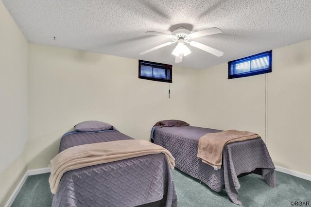 bedroom featuring ceiling fan, carpet flooring, and a textured ceiling