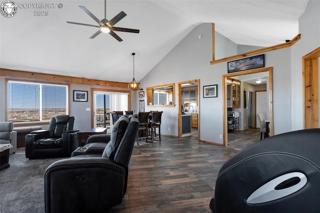 living area featuring high vaulted ceiling, dark wood-style flooring, a ceiling fan, and baseboards