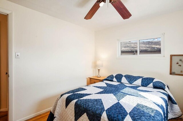 bedroom featuring hardwood / wood-style flooring and ceiling fan