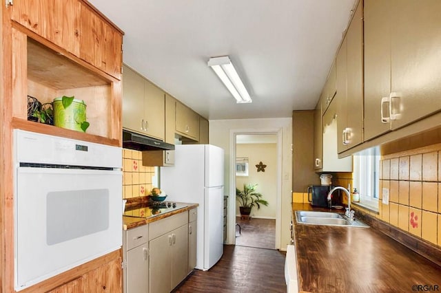 kitchen featuring sink, white appliances, and dark wood-type flooring