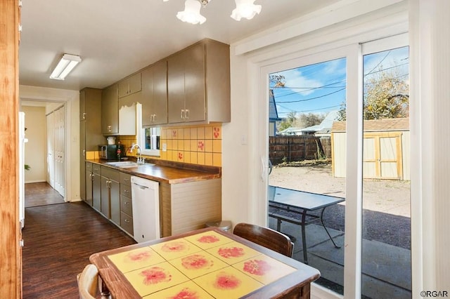 kitchen with dark hardwood / wood-style flooring, sink, plenty of natural light, and dishwasher