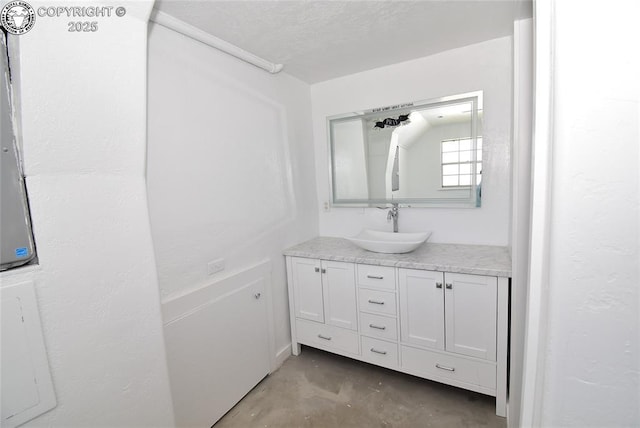 bathroom featuring vanity and unfinished concrete flooring