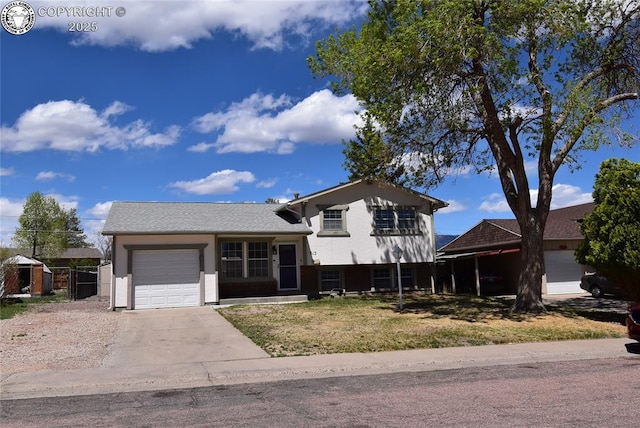 split level home featuring an attached garage and driveway