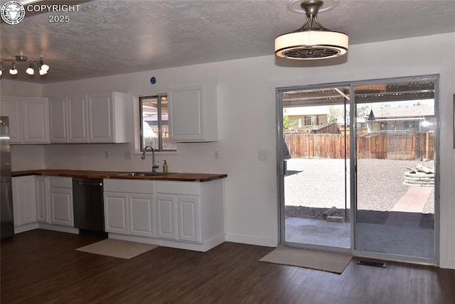 kitchen with a sink, dark wood finished floors, a wealth of natural light, and dishwasher