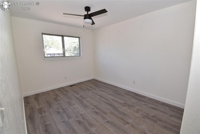 unfurnished room featuring baseboards, a ceiling fan, and wood finished floors