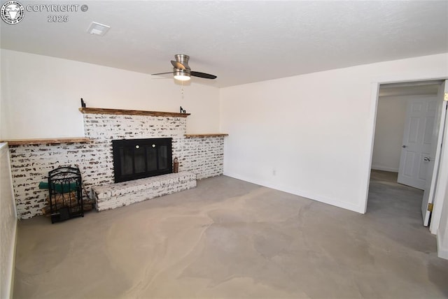 unfurnished living room with a ceiling fan, baseboards, and a fireplace