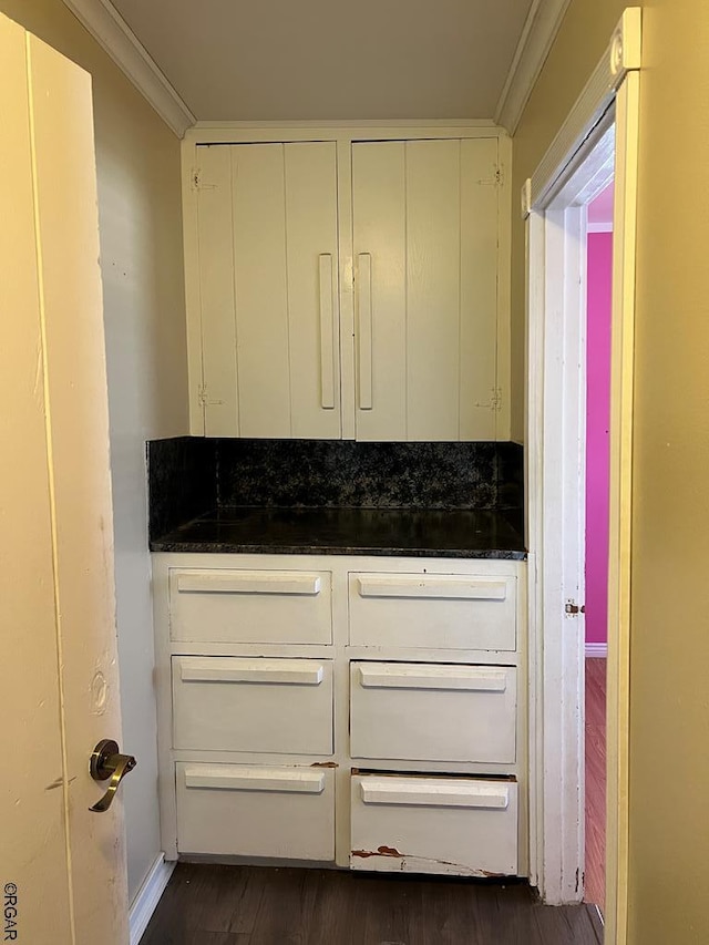 bathroom featuring wood-type flooring and ornamental molding