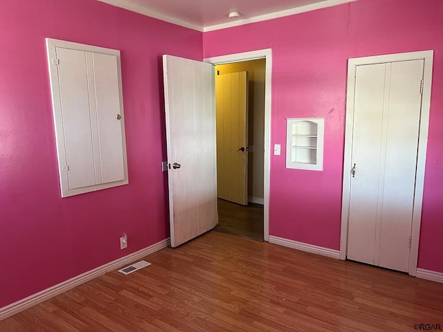 unfurnished bedroom featuring hardwood / wood-style floors