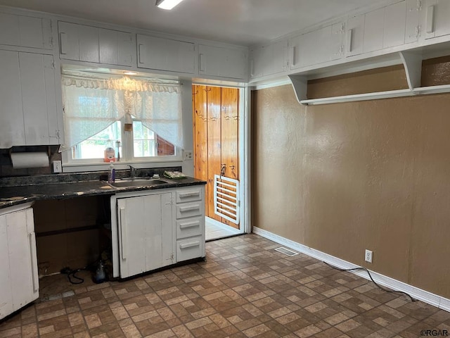 kitchen with white cabinetry and sink