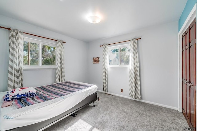 carpeted bedroom with a closet