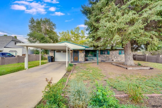 view of front of home with a garage, a front lawn, and a carport