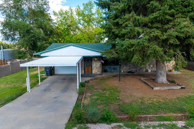 view of front of property with a carport and a front lawn