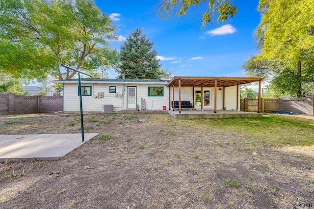 rear view of property with central AC and a patio