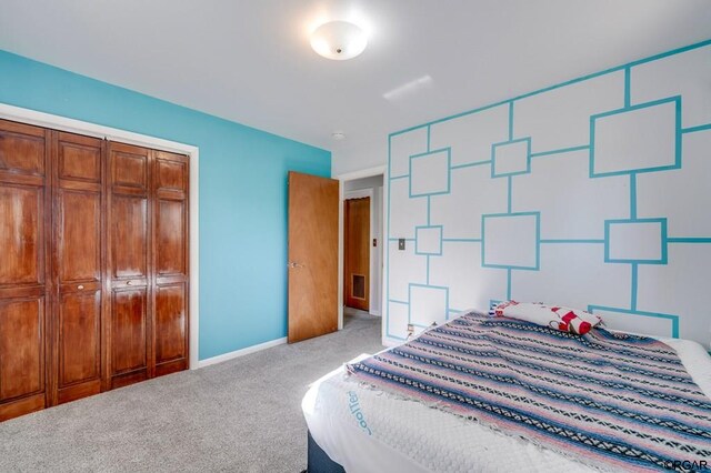 bedroom featuring light carpet and a closet