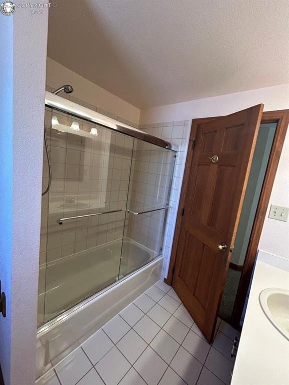 2324 W Willamette Ave, Colorado Springs, CO 80904 - bathroom with vanity, a textured ceiling, enclosed tub / shower combo, and tile patterned floors