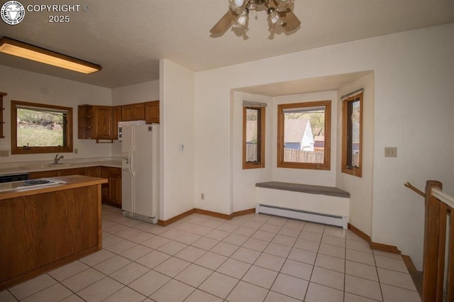 2324 W Willamette Ave, Colorado Springs, CO 80904 - kitchen featuring brown cabinetry, white refrigerator with ice dispenser, a baseboard heating unit, stovetop, and a ceiling fan