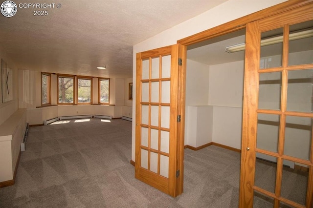 2324 W Willamette Ave, Colorado Springs, CO 80904 - interior space featuring baseboard heating, carpet floors, a textured ceiling, baseboards, and a baseboard heating unit