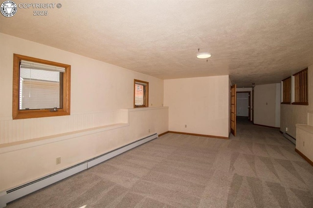 2324 W Willamette Ave, Colorado Springs, CO 80904 - empty room featuring carpet floors, baseboards, baseboard heating, and a textured ceiling