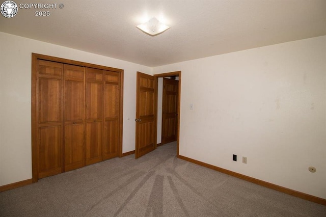 2324 W Willamette Ave, Colorado Springs, CO 80904 - unfurnished bedroom with baseboards, a closet, and light colored carpet