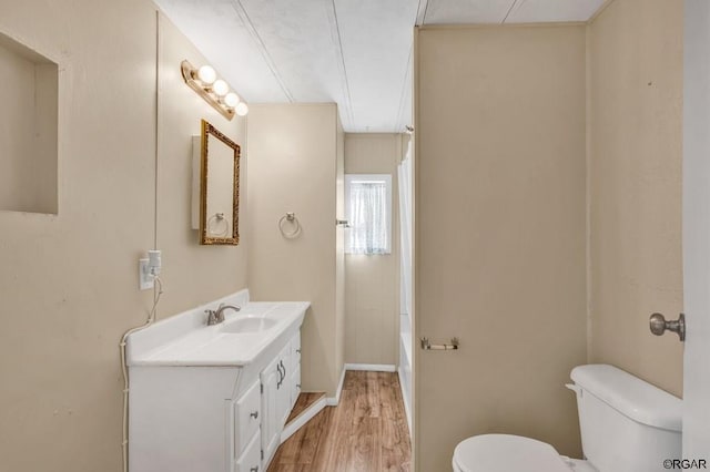 bathroom featuring crown molding, vanity, toilet, and hardwood / wood-style floors