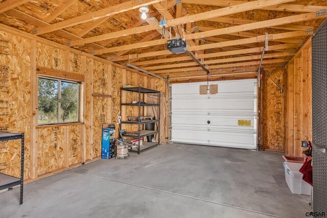 garage with a garage door opener and wooden walls