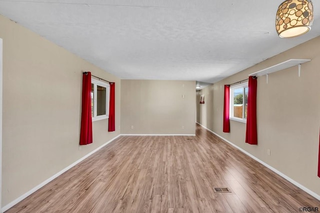 unfurnished room featuring light hardwood / wood-style floors