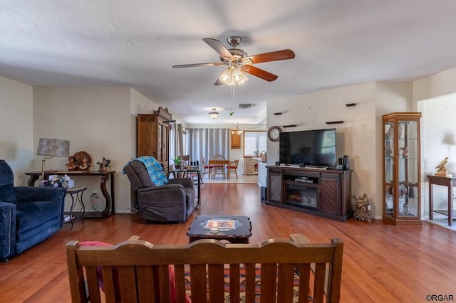 living room with hardwood / wood-style flooring and ceiling fan