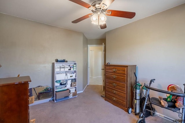 interior space featuring light carpet and ceiling fan