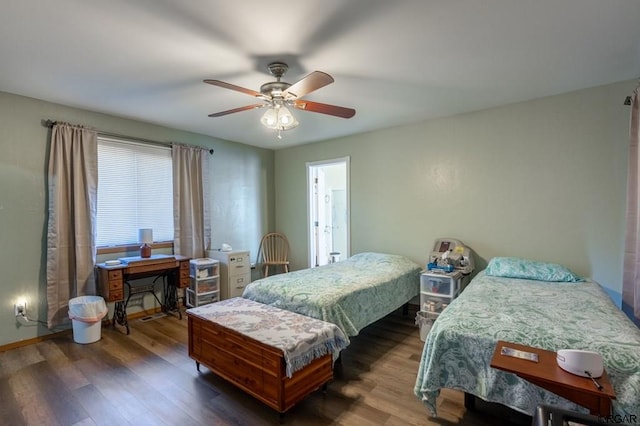 bedroom with dark hardwood / wood-style flooring and ceiling fan