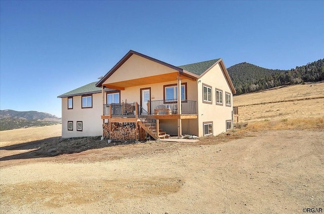 rear view of house featuring a mountain view