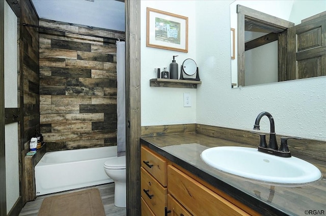 full bathroom featuring vanity, shower / bathing tub combination, hardwood / wood-style floors, and toilet