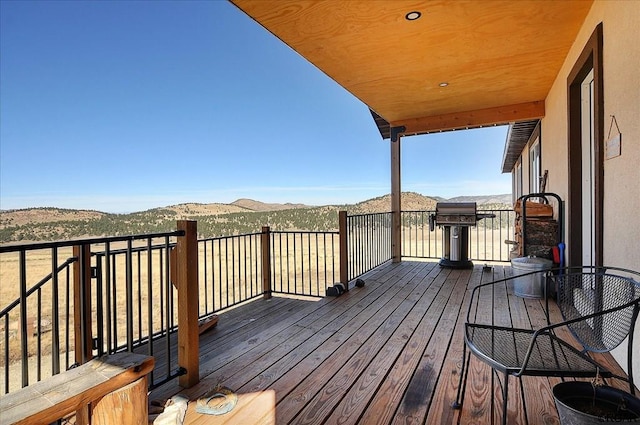 wooden deck with a mountain view