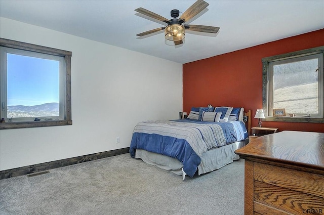 bedroom featuring ceiling fan and carpet