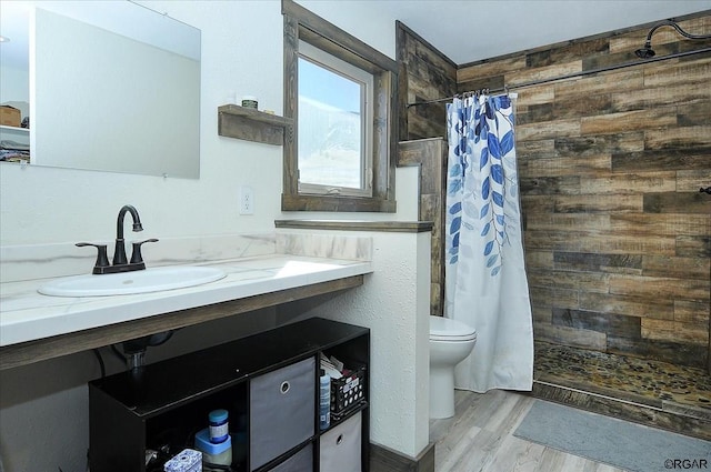 bathroom featuring hardwood / wood-style flooring, vanity, toilet, and a shower with shower curtain