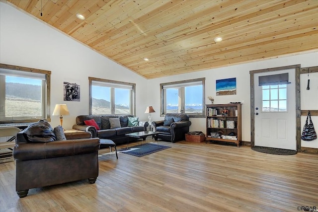 living room with wood ceiling, a mountain view, high vaulted ceiling, and light wood-type flooring