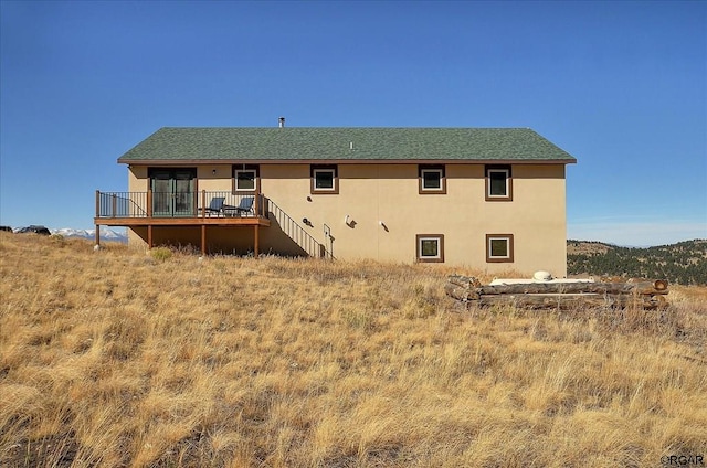 back of house featuring a deck