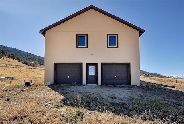 exterior space featuring a garage and a mountain view