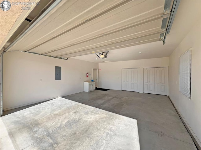 garage with a garage door opener and electric panel