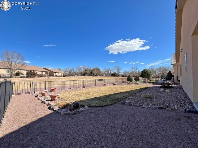 view of yard with a fenced backyard and a residential view