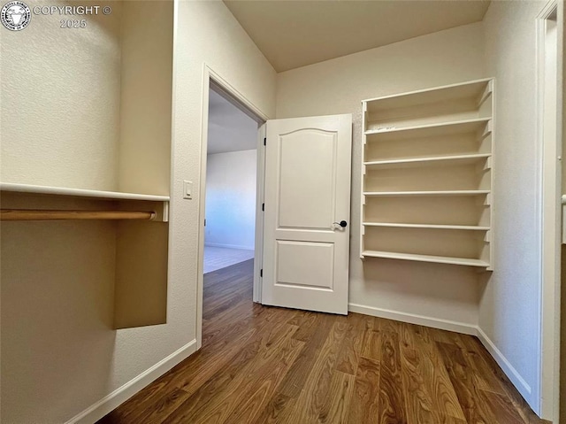 interior space featuring dark wood-style floors and baseboards