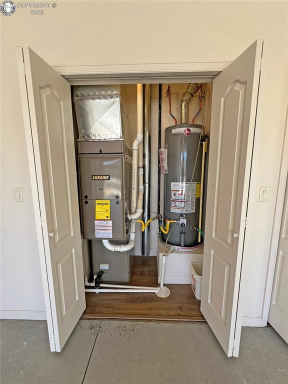 utility room with gas water heater