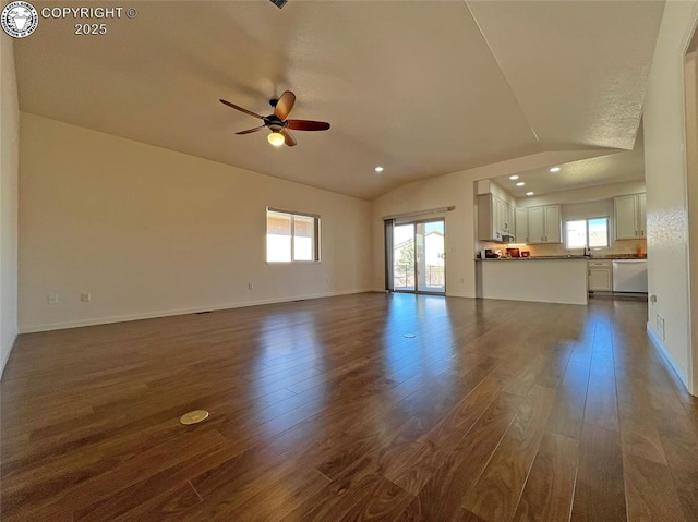 unfurnished living room featuring lofted ceiling, baseboards, and dark wood-type flooring