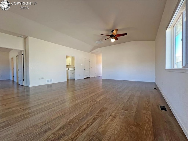 unfurnished living room with a ceiling fan, lofted ceiling, visible vents, and dark wood finished floors