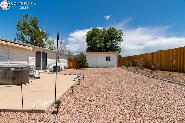 20 Kodiak Cir, Canon City, CO 81212 - fenced backyard featuring a hot tub, a patio area, and an outdoor structure