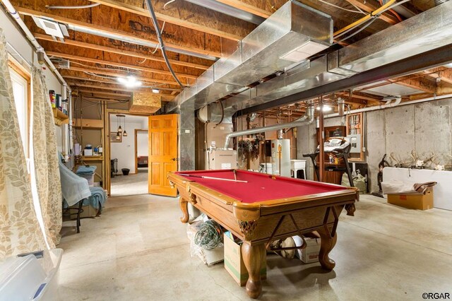 game room with water heater, concrete floors, and billiards