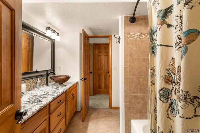 bathroom featuring vanity, a textured ceiling, and shower / bathtub combination with curtain