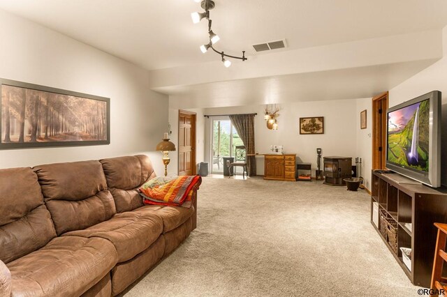 living room with rail lighting and carpet flooring